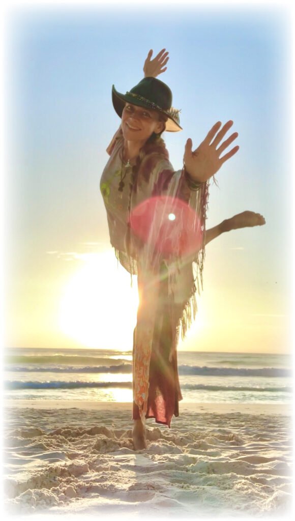 Betsy Boots on the beach with the sun in the background.